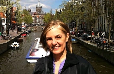 Color photograph of writer Sheryl St. Germain with their back to a canal
