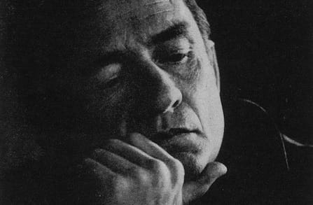 Image of Johnny Cash with a hand on his chin.