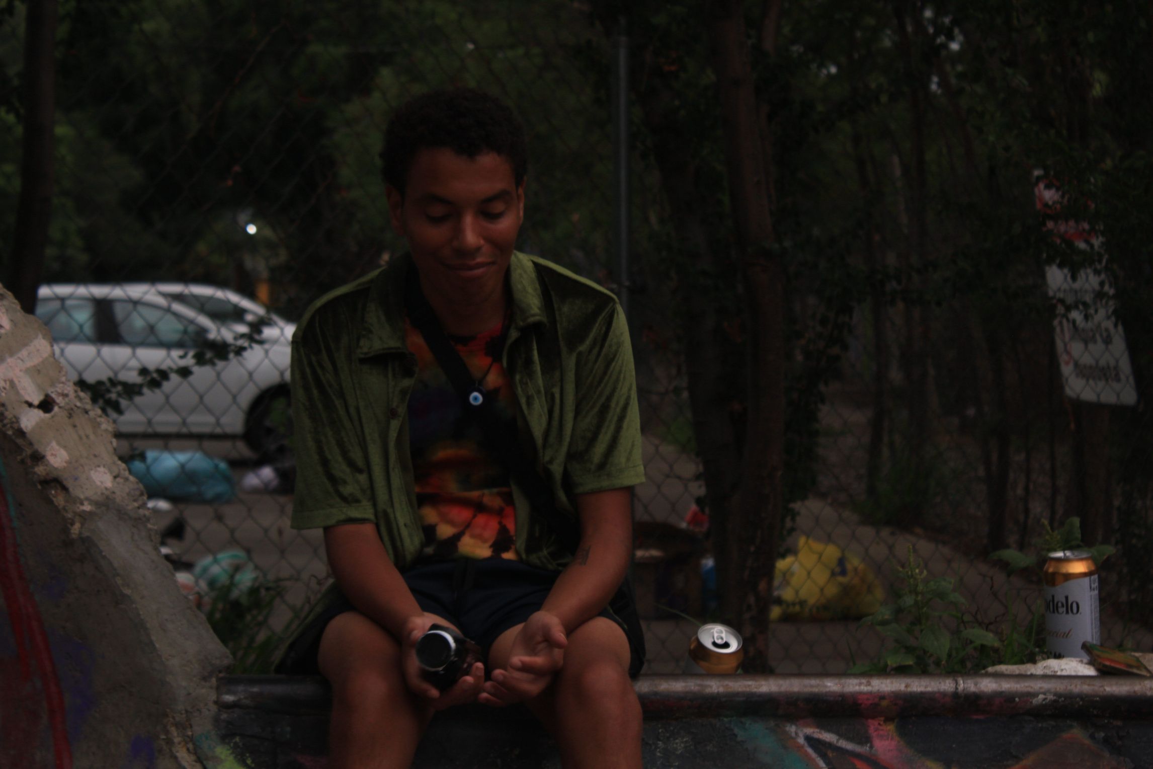 Charles Shields, the author, sits on the coping of a skate park.