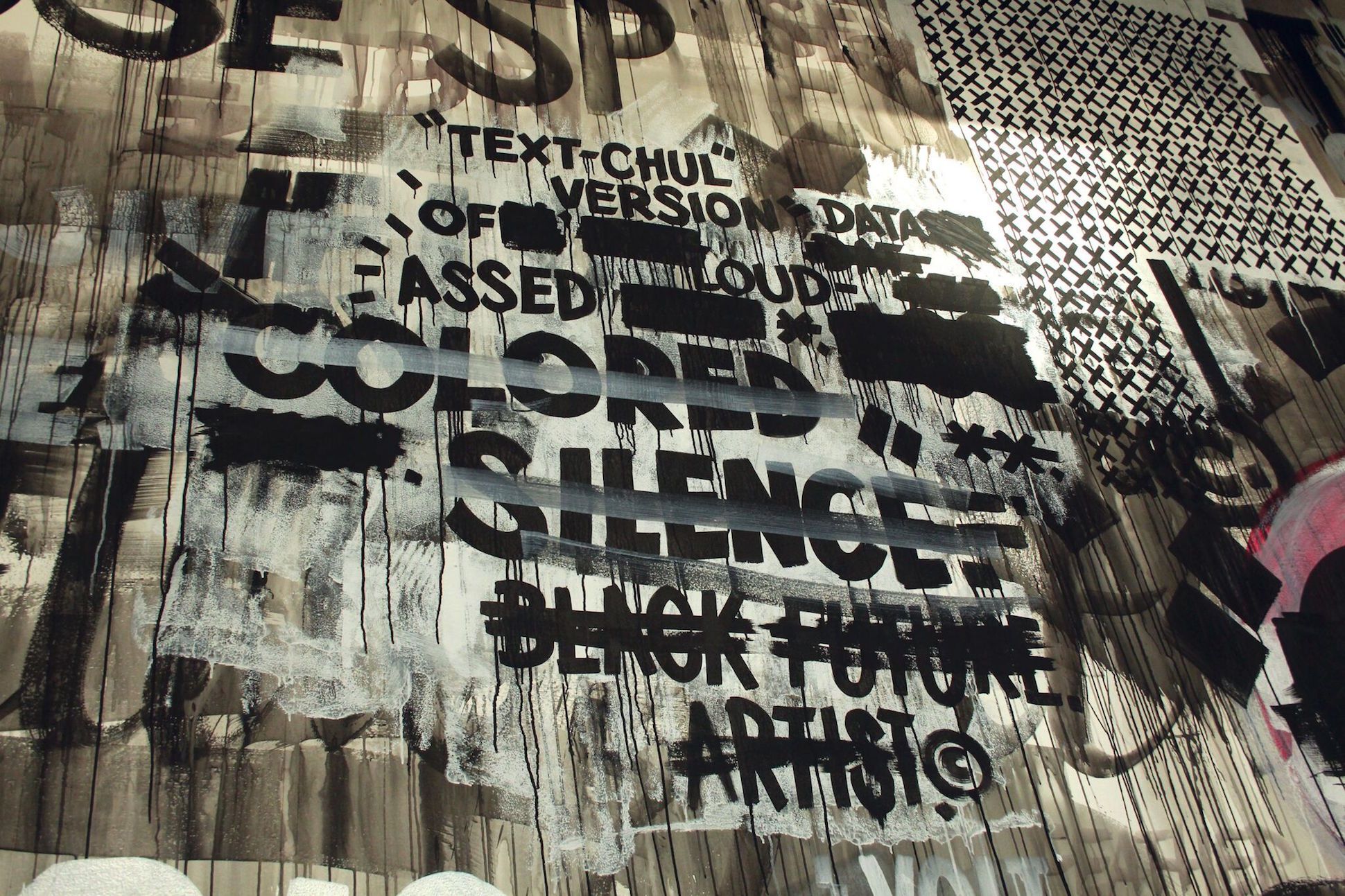 Detail of installation featuring several different darkly painted images on a white wall. Image features texts, a series of X's, and dripping black paint.