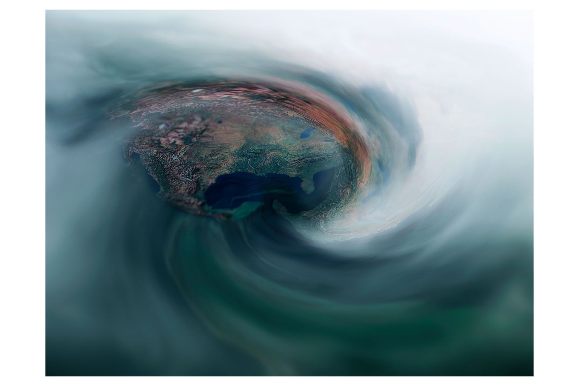 Photo of a hurricane swirl, with a distant, aerial view of land.