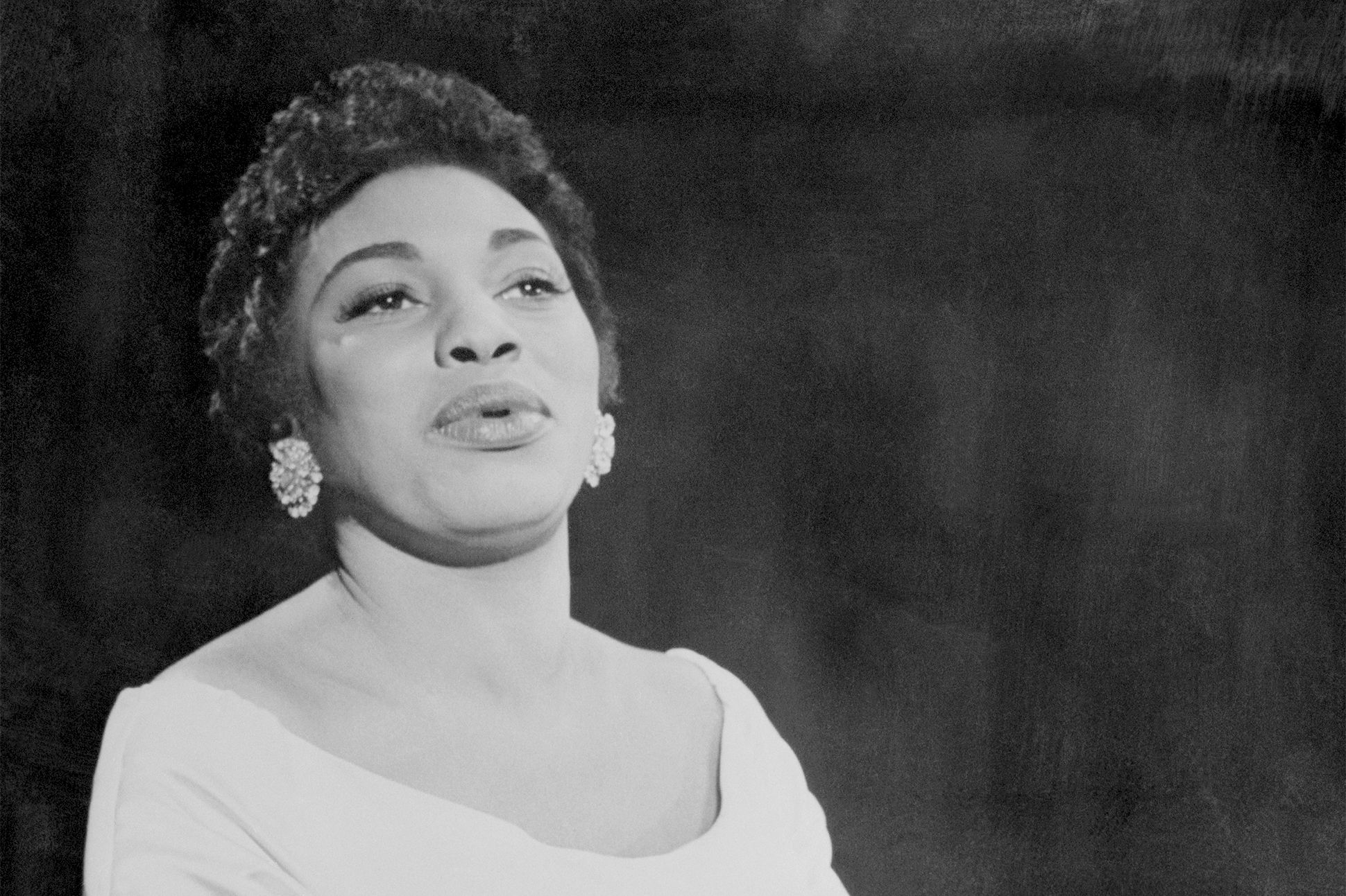 Black-and-white portrait of Leontyne Price singing.