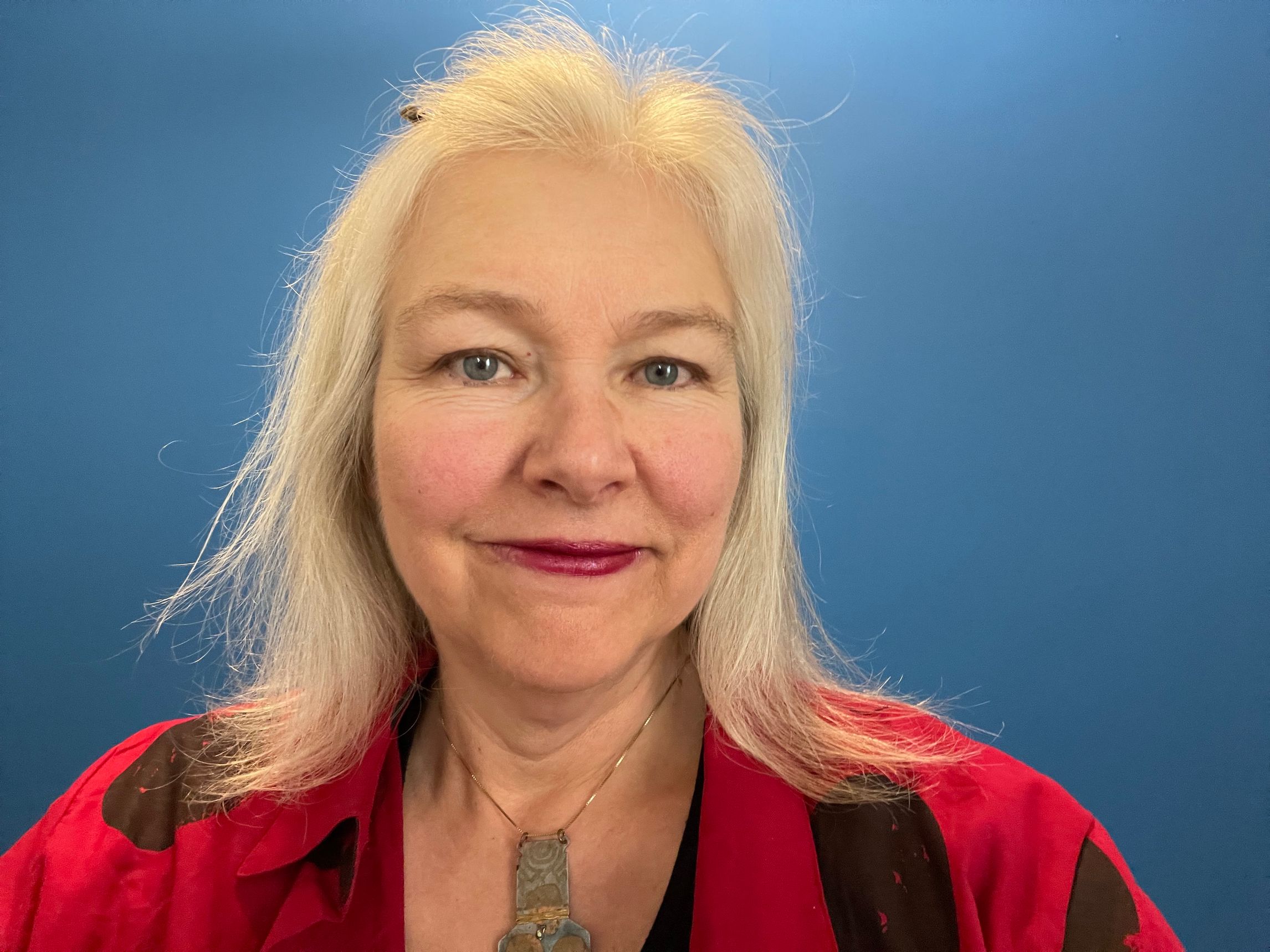 Photo of Audre Budrys, Lithuanian-American woman, against a blue background.