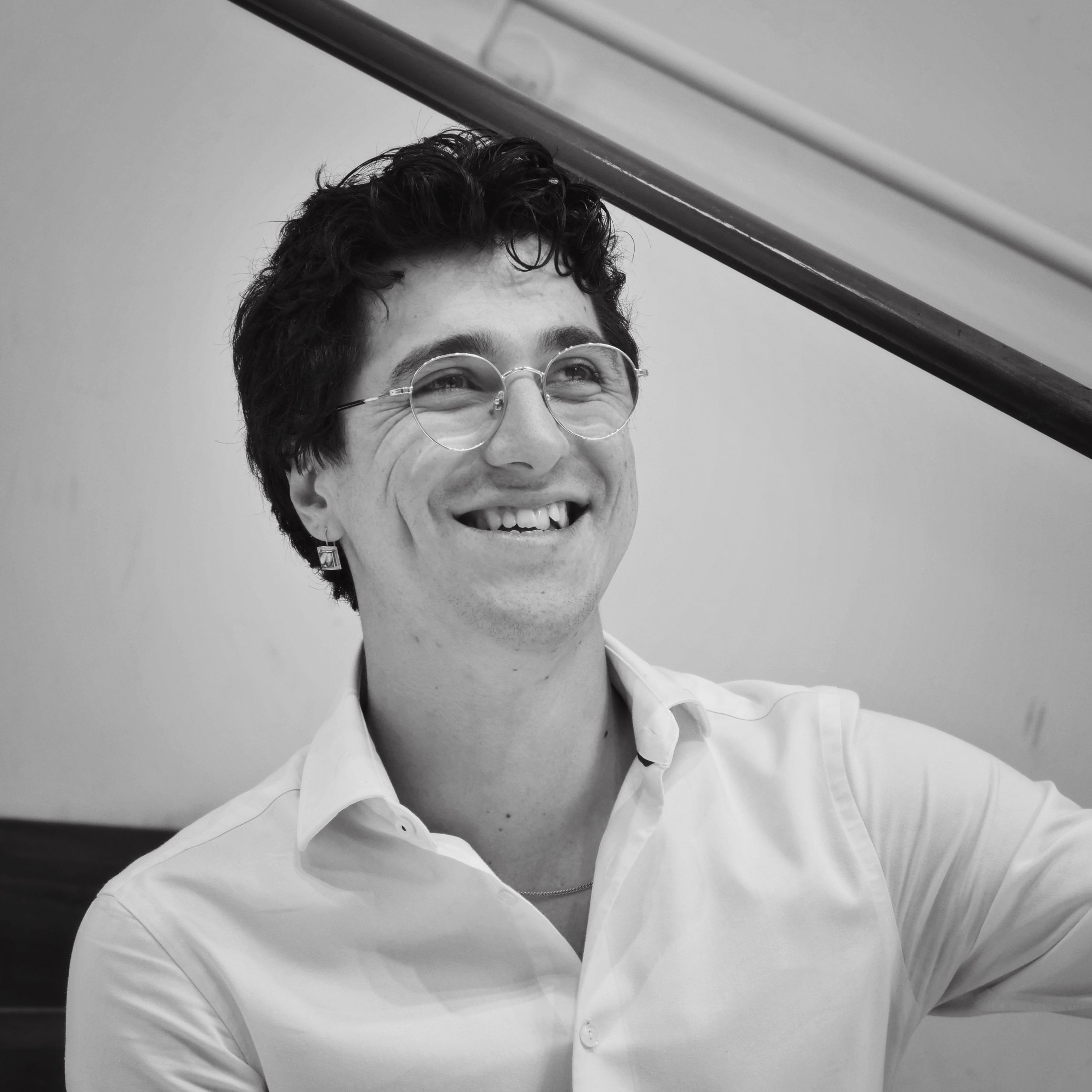 Pradeau, a white man with black hair, wearing a white button-down.