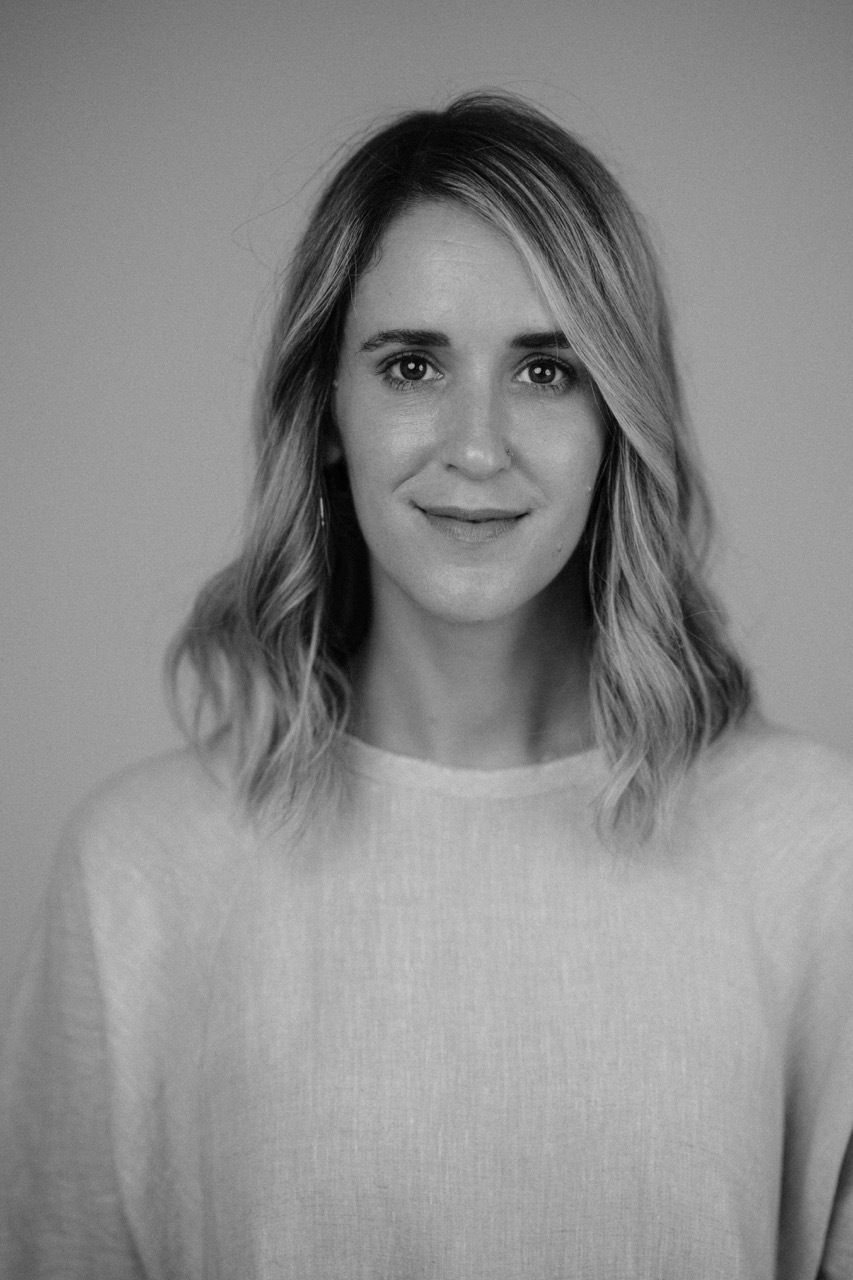 Black and white photo of Caroline Cabrera, a white woman with blonde hair and beige dress